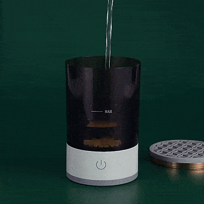 Automatic electric makeup brush cleaner in action removing pigment