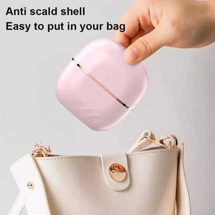 Portable travel hair straightener in use straightening hair strands