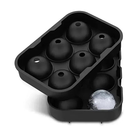 Slow-melting round ice balls from silicone mold tray chilling cocktail drinks